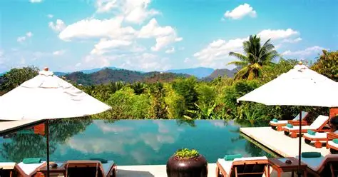 Infinity pool at Belmond La Résidence Phou Vao reflecting the mountains of Luang Prabang